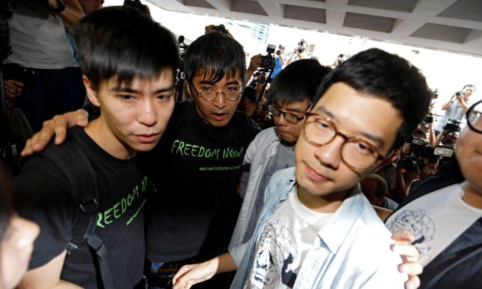 Hong Kong Democracy Leader Defiant as Three Jailed for Months
