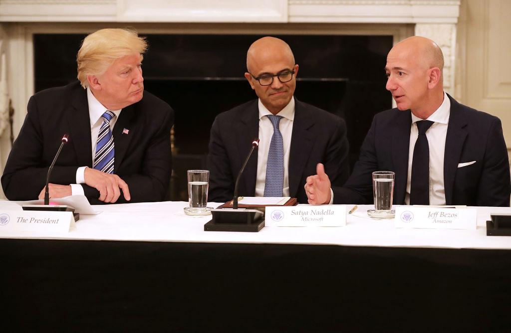 President Donald Trump, Microsoft CEO Satya Nadella, and Amazon CEO Jeff Bezos attend a meeting of the American Technology Council in the State Dining Room of the White House in Washington, DC, on June 19, 2017. (Chip Somodevilla/Getty Images)