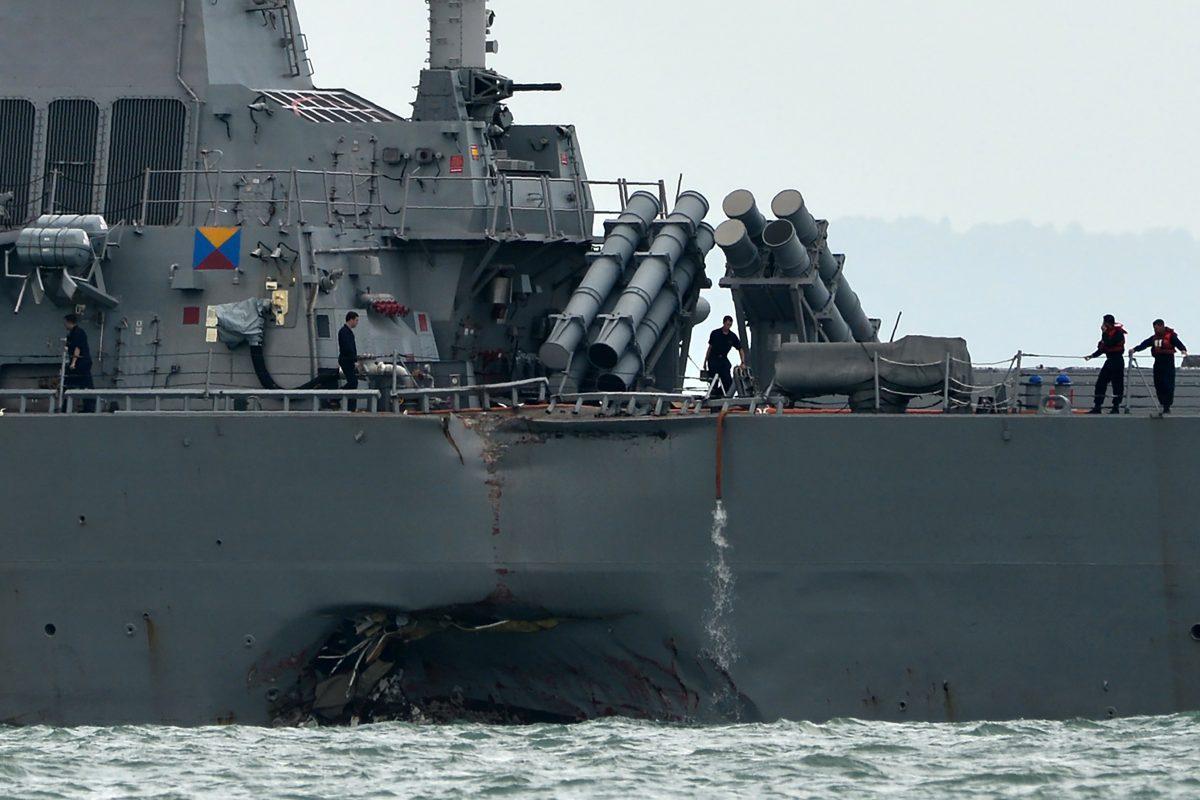 The guided-missile destroyer USS John S. McCain is seen with a hole on its portside after a collision with an oil tanker outside Changi Naval Base in Singapore on Aug. 21, 2017. An admiral in the PLA Navy celebrated the collision, which involved the loss of American life. (Roslan Rahman/AFP/Getty Images)