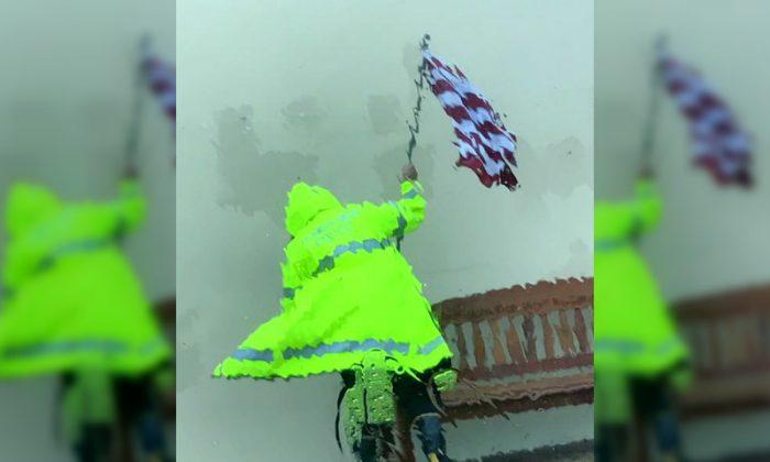 Police Officer Takes Risk to Save American Flag During Hurricane Harvey