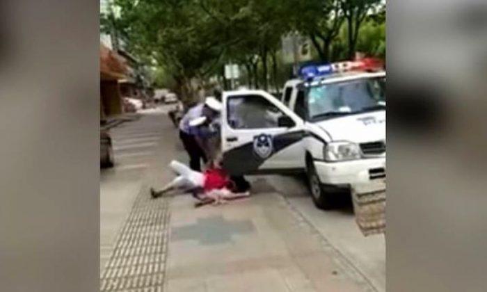 Video of Chinese Police Officer Slamming Woman, Child Draws Ire