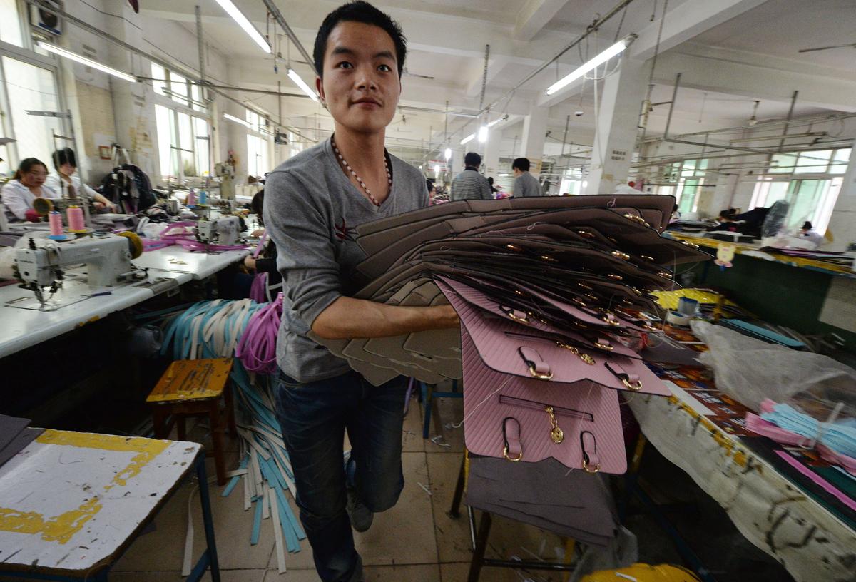 Workers at a handbag factory in Baigou, Hebei Province, complete orders to be sold through the Chinese internet e-commerce site Taobao, in this file photo. (Mark Ralston/AFP/Getty Images)