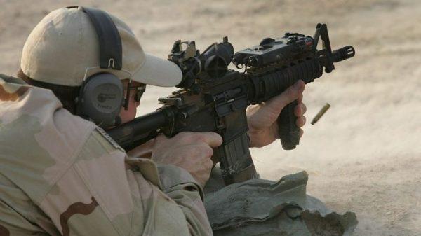 A U.S. Navy SEAL fires his M-4 assault rifle during a training session with Iraqi army scouts in Fallujah, Iraq on July 26, 2007. (John Moore/Getty Images)