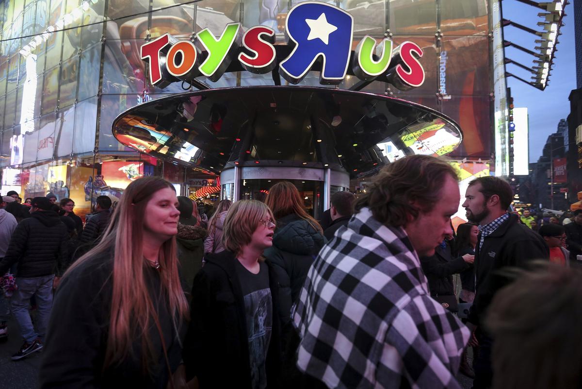 People walk past Toys R Us in Times Square the day after Christmas in the Manhattan borough of New York on Dec. 26, 2015. (REUTERS/Carlo Allegri)