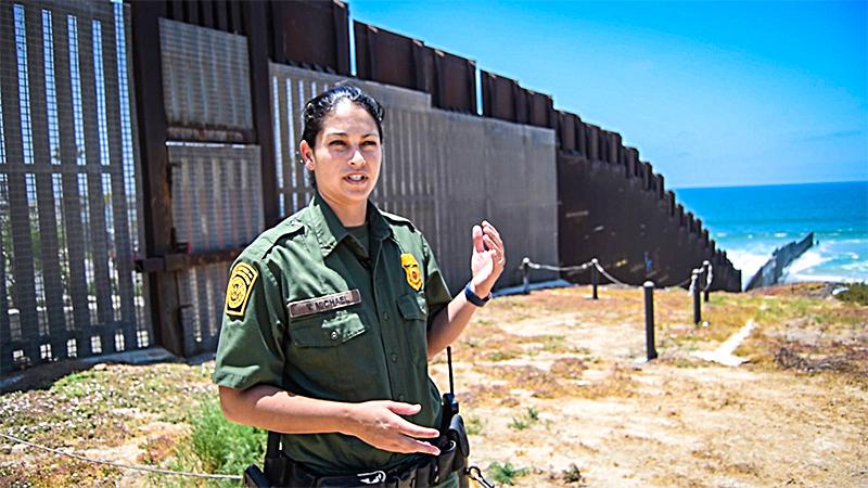 San Diego Border Patrol agent Tekae Michael at the western end of the U.S.–Mexico border barrier in San Diego on July 12. The "PV-1" barrier is designed to stop both pedestrians and vehicles from illegally crossing the border. (Joshua Philipp/The Epoch Times)
