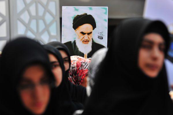 A Turkish Muslim woman holds a picture of Iran's late leader Ayatollah Khomeini during a protest in front of Beyazit Mosque after a Friday prayer in Istanbul on Aug. 26, 2011. (Mustafa OzerAFP/Getty Images)