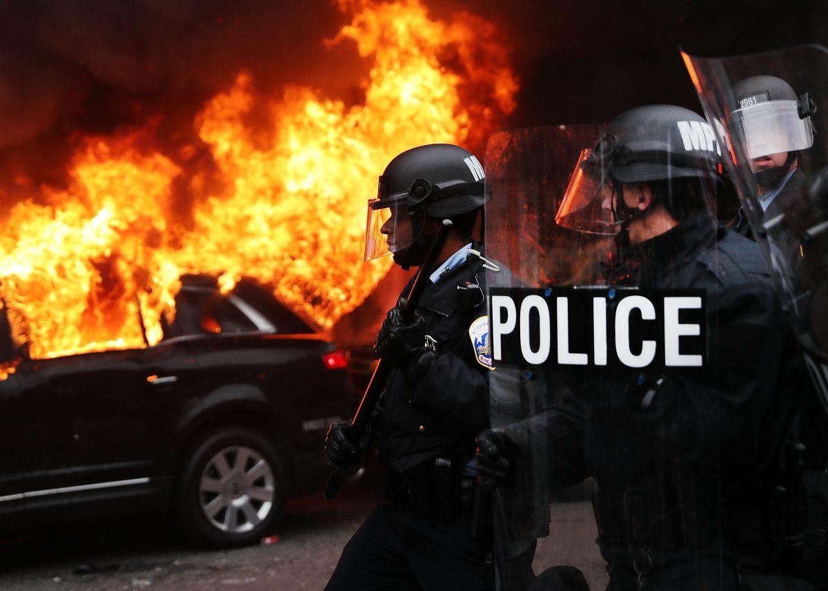 Police and demonstrators clash in downtown Washington after a limo was set on fire following the inauguration of President Donald Trump on Jan. 20, 2017 in Washington, DC. Washington and the entire world have watched the transfer of the United States presidency from Barack Obama to Donald Trump, the 45th president. (Spencer Platt/Getty Images)