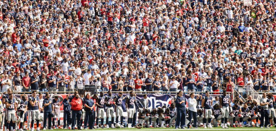 Members of the New England Patriots kneel on the sidelines as the National Anthem is played before a game against the Houston Texans at Gillette Stadium in Foxboro, Mass., on Sept. 24, 2017. (Billie Weiss/Getty Images)