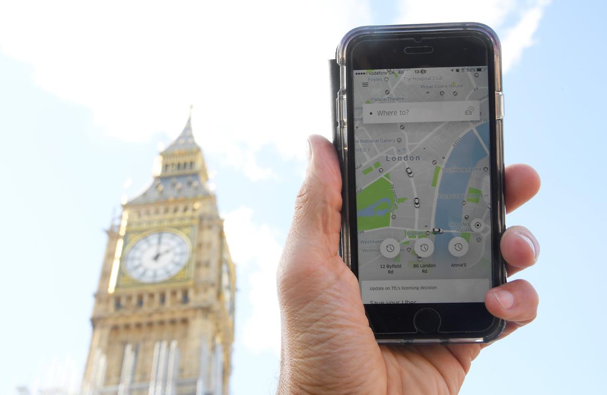 A photo illustration shows the Uber app on a mobile telephone, as it is held up for a posed photograph in central London, Britain on Sept. 22, 2017. (REUTERS/Toby Melville)