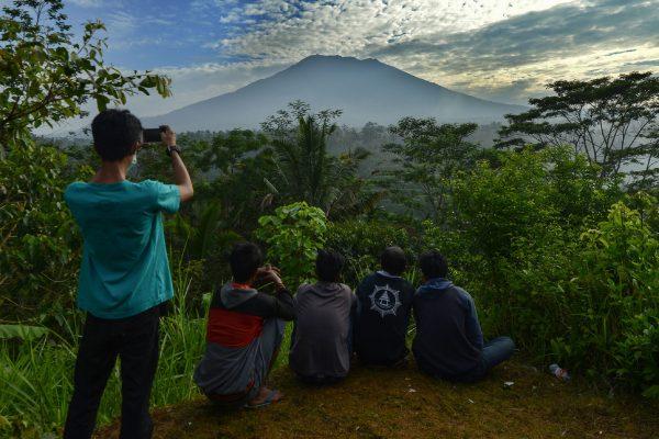 People look at Mount Agung on the Indonesian resort island of Bali on Sept. 24, 2017. (Sonny Tumbelaka/AFP/Getty Images)