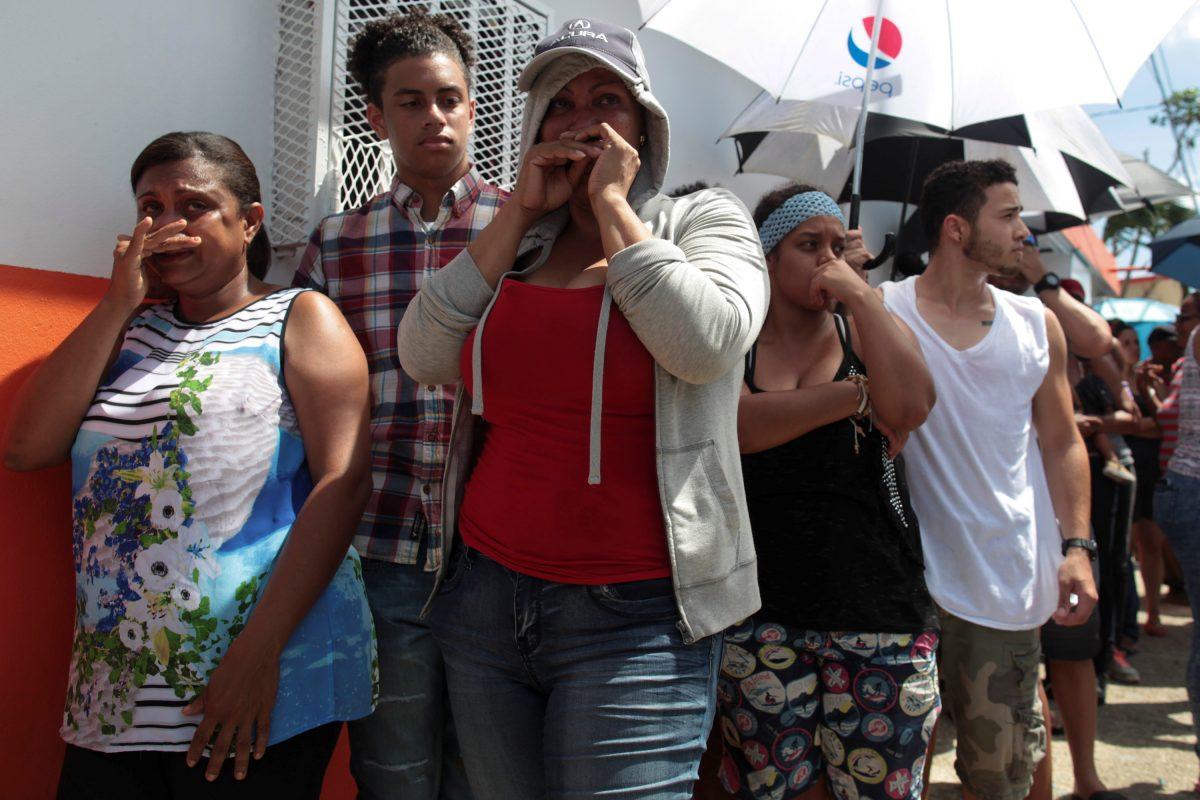 People wait in line for aid items to be handed out in San Juan. (Reuters/Alvin Baez)