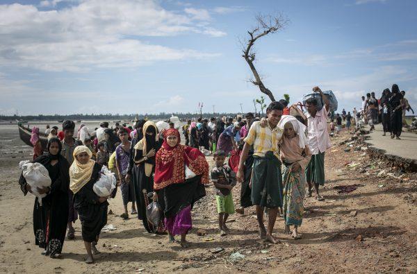 Rohingya refugees make their way along a beach after arriving by boat at Shah Porir Dip, Bangladesh, on Sept. 14, 2017. (Allison Joyce/Getty Images)