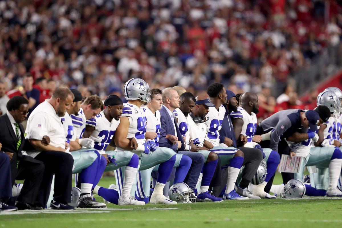 Members of the Dallas Cowboys take a knee before the start of the national anthem at an NFL game against the Arizona Cardinals at the University of Phoenix Stadium in Glendale, Arizona, on Sept. 25, 2017. (Christian Petersen/Getty Images)