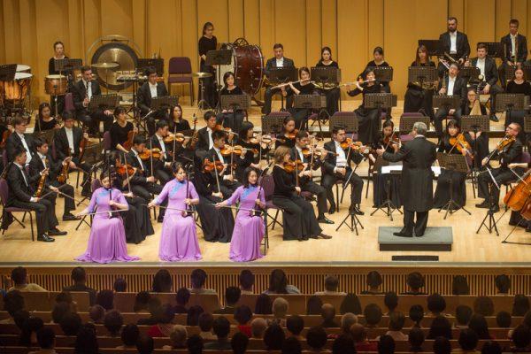 Three erhu soloists, in purple dresses, leading the Shen Yun Symphony Orchestra at Pingtung County Performing Arts Center-Concert Hall, on Sept. 24, 2017. (Lo Jui-hsun/The Epoch Times)