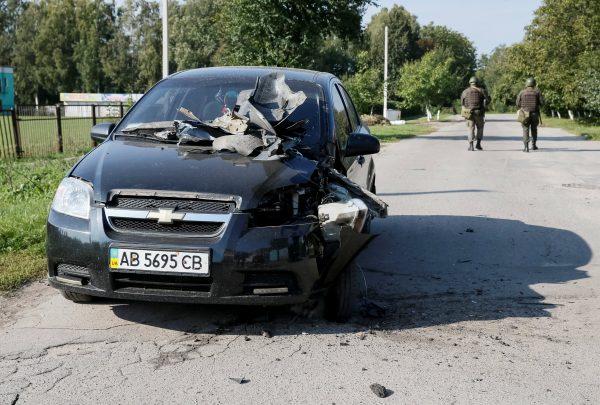 A destroyed car is seen as National Guards patrol the area near the warehouse storing ammunition for multiple rocket launcher systems at a military base in Kalynivka, Vinnytsia region, Ukraine Sep. 27, 2017. (Reuters/Gleb Garanich)