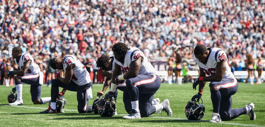 Members of the Houston Texans kneel before a game against the New England Patriots at Gillette Stadium on September 24, 2017, in Foxboro, Mass.. (Billie Weiss/Getty Images)