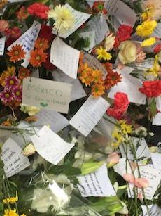 Messages on flowers at the memorial offer prayers and condolences. (Anthony Hoffman)