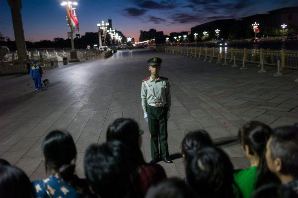 A paramilitary guard stands in front of a crowd at Tiananmen Square in Beijing on September 20, 2017. (Fred Dufour/AFP/Getty Images)