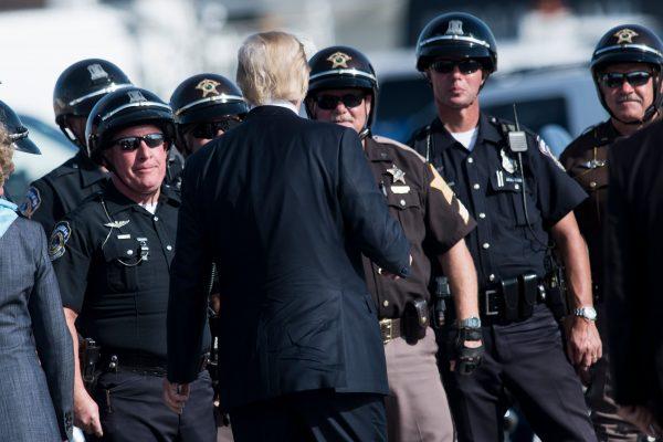 President Donald Trump talks to motorcycle police before boarding Air Force One at Indianapolis International Airport on Sept. 27. (BRENDAN SMIALOWSKI/AFP/Getty Images)
