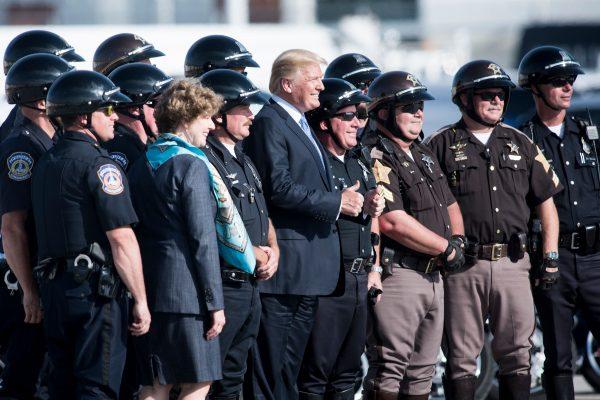 President Donald Trump poses for a photo with motorcycle police before boarding Air Force One at Indianapolis International Airport on Sept. 27. (BRENDAN SMIALOWSKI/AFP/Getty Images)