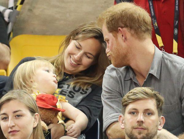Prince Harry (R) sits with David Henson's wife Hayley Henson (L) and daughter Emily Henson at the Sitting Volleyball Finals during the Invictus Games 2017 at Mattamy Athletic Centre on Sept. 27, 2017, in Toronto. (Chris Jackson/Getty Images for the Invictus Games Foundation)