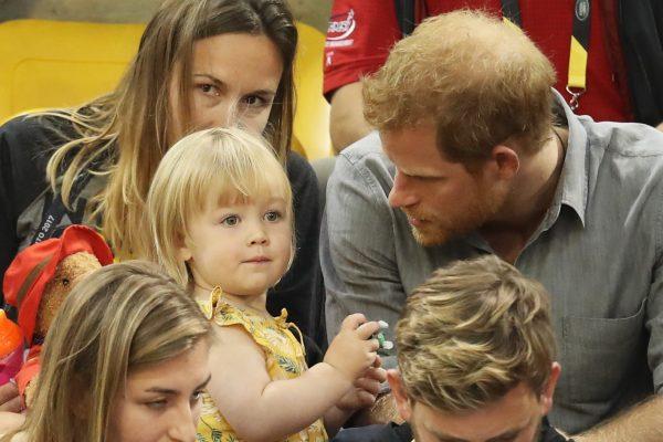 Prince Harry (R) sits with David Henson's wife Hayley Henson (L) and daughter Emily Henson at the Sitting Volleyball Finals during the Invictus Games 2017 at Mattamy Athletic Centre on Sept. 27, 2017, in Toronto. (Chris Jackson/Getty Images for the Invictus Games Foundation)