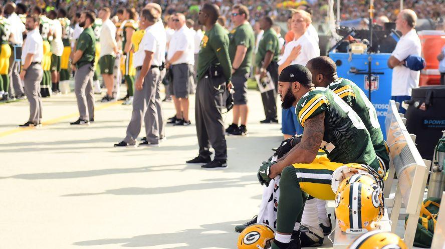 Green Bay Packers players sit in protest during the national anthem prior to the game against the Cincinnati Bengals at Lambeau Field on Sept. 24, 2017, in Green Bay, Wis. (Stacy Revere/Getty Images)