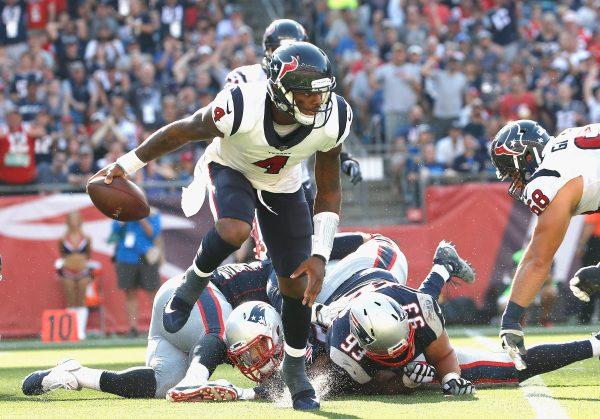 Deshaun Watson (L) of the Houston Texans scrambles with the ball during the fourth quarter of a game against the New England Patriots at Gillette Stadium in Foxboro, Mass., on Sept. 24, 2017. (Jim Rogash/Getty Images)
