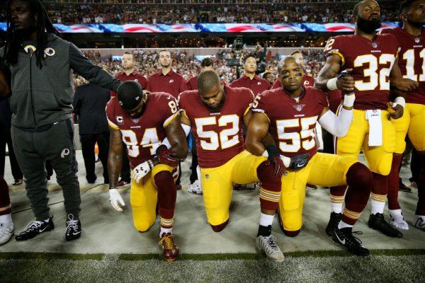 Washington Redskins players during the the national anthem before the game against the Oakland Raiders at FedExField in Landover, Md., on Sept. 24, 2017. (Patrick Smith/Getty Images