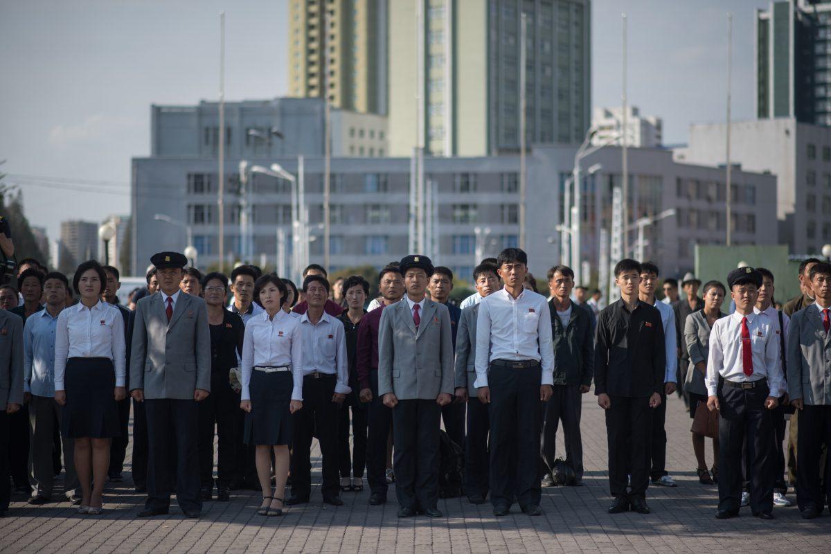 North Koreans watch a statement delivered by dictator Kim Jong Un on a television screen outside of the railway station in Pyongyang, North Korea, on Sept. 22. (ED JONES/AFP/Getty Images)