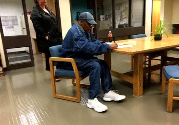 Former football legend O.J. Simpson signs documents at the Lovelock Correctional Center in Lovelock, Nev., on Sept. 30, 2017. (Nevada Department of Corrections via Reuters)