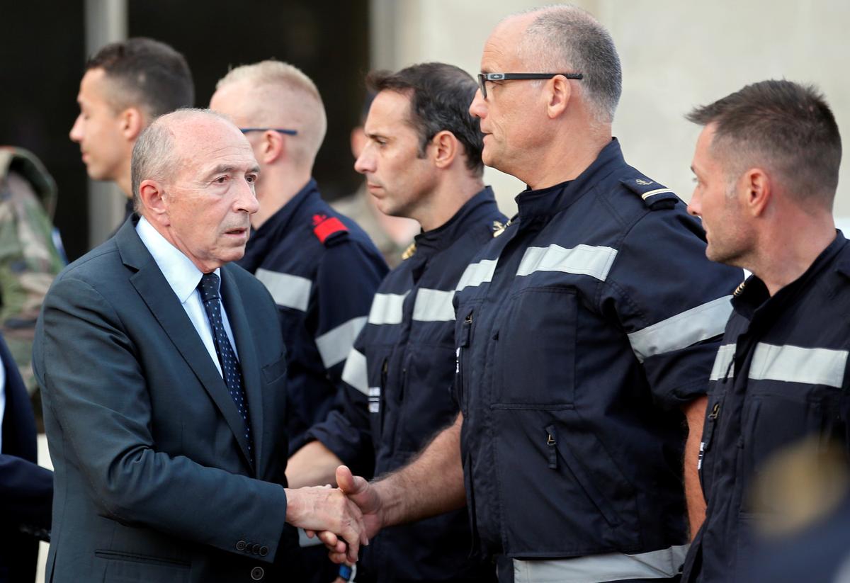 French Interior Minister Gerard Collomb meets with firemen outside the Saint-Charles train station after French soldiers shot and killed a man who stabbed two women to death at the main train station in Marseille, France on Oct. 1, 2017. (REUTERS/Jean-Paul Pelissier)
