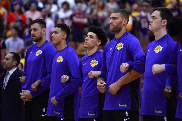(L–R) Andrew Bogut, Kyle Kuzma, Lonzo Ball, Brook Lopez and Stephen Zimmerman of Los Angeles Lakers lock arms during the national anthem before the start of the game against the Minnesota Timberwolves at the Honda Center in Anaheim, Calif., on Sept. 30, 2017. (Robert Laberge/Getty Images)