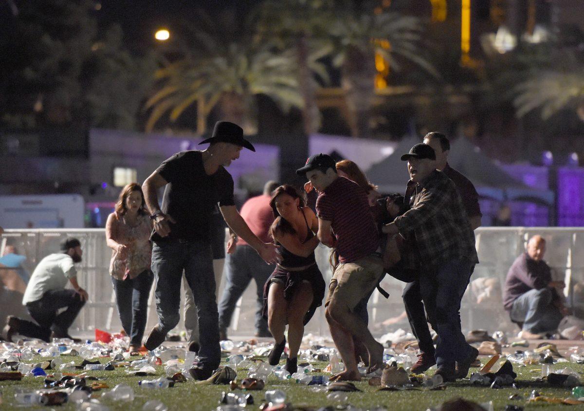 People carry a person at the Route 91 Harvest country music festival after a man opened fire on a crowd from the 32nd floor in Las Vegas on Oct. 1, 2017. (David Becker/Getty Images)