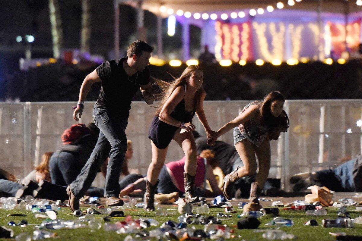 People run away from gunfire in Las Vegas on Oct. 1. At least 50 people were killed and over 400 injured when a gunman opened fire on concertgoers. (David Becker/Getty Images)
