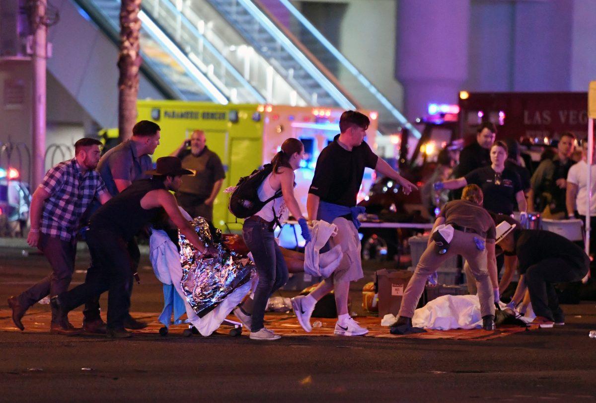 An injured person is tended to in the intersection of Tropicana Ave. and Las Vegas Boulevard after a mass shooting at a country music festival nearby in Las Vegas on Oct. 2, 2017 . (Ethan Miller/Getty Images)