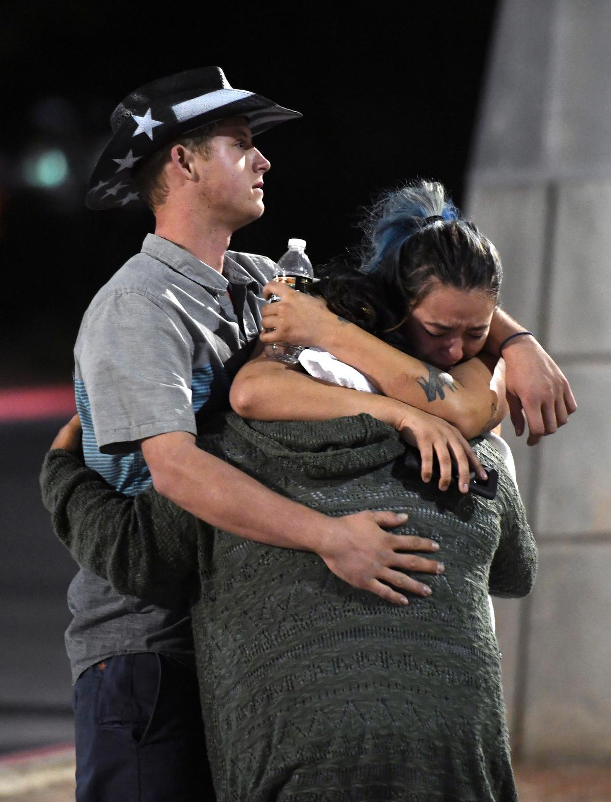 People hug and cry outside the Thomas &; Mack Center after a mass shooting at the Route 91 Harvest country music festival in Las Vegas, Nevada on Oct. 2, 2017. (Ethan Miller/Getty Images)
