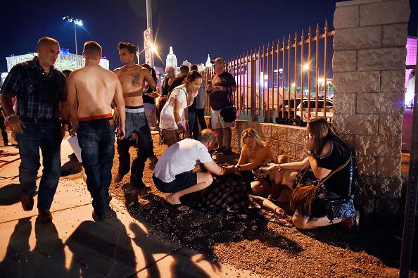 People tend to the wounded outside the Route 91 Harvest country music festival after gunfire was heard in Las Vegas on Oct. 1, 2017. (David Becker/Getty Images)