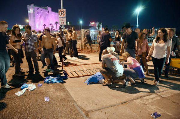 People tend to the wounded outside the Route 91 Harvest country music festival after gunfire was heard in Las Vegas on Oct. 1, 2017. (David Becker/Getty Images)