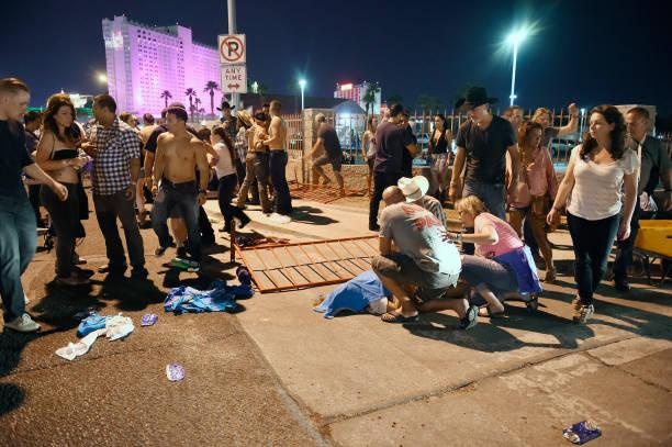 People tend to the wounded outside the Route 91 Harvest Country music festival grounds after an apparent shooting in Las Vegas, Nevada. There are reports of an active shooter around the Mandalay Bay Resort and Casino on Oct. 1, 2017. (David Becker/Getty Images)