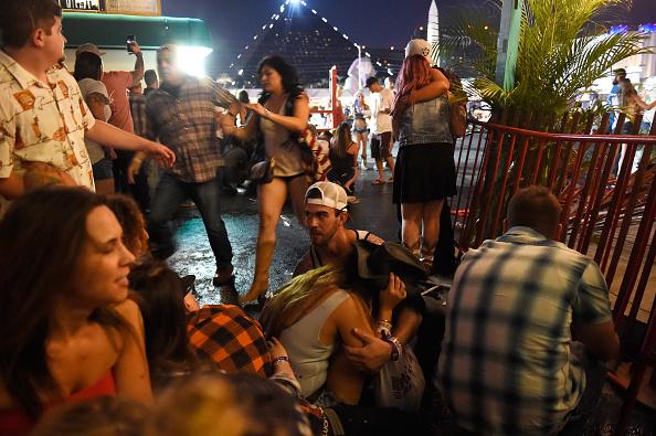 People run for cover at the Route 91 Harvest country music festival after gunfire was heard in Las Vegas on Oct. 1, 2017. (David Becker/Getty Images)