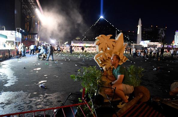 A person takes cover at the Route 91 Harvest country music festival after gunfire was heard in Las Vegas on Oct. 1, 2017. (David Becker/Getty Images)