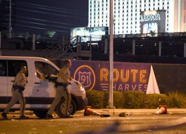 Las Vegas police run by a banner on the fence at the Route 91 Harvest country music festival grounds after an active shooter was reported in Las Vegas on Oct. 2, 2017. (David Becker/Getty Images)