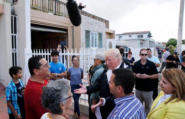 President Donald Trump talks with local residents during a walking tour of areas damaged by Hurricane Maria in Guaynabo, Puerto Rico, on Oct. 3, 2017. (Jonathan Ernst/Reuters)