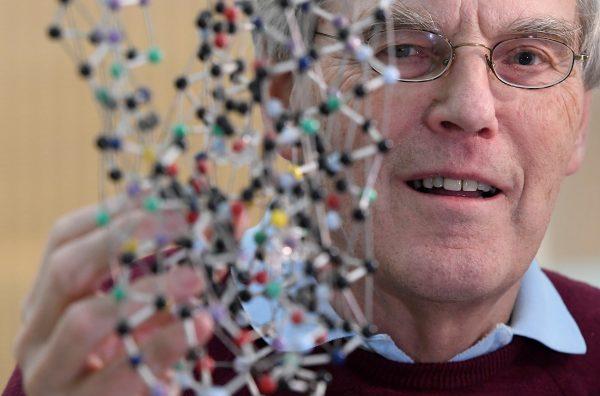 Molecular biologist and biophysicist Richard Henderson poses as he looks through a bacteriorhodopsin protein model, following the announcement that he is a joint winner of the 2017 Nobel Prize in Chemistry, at the MRC Laboratory of Molecular Biology in Cambridge, Britain October 4, 2017. REUTERS/Toby Melville