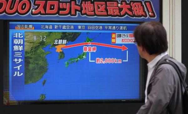 A pedestrian looks at a television screen displaying a map of Japan (R) and the Korean Peninsula in Tokyo following a North Korean missile test that passed over Japan on Sept. 15, 2017. (KAZUHIRO NOGI/AFP/Getty Images)