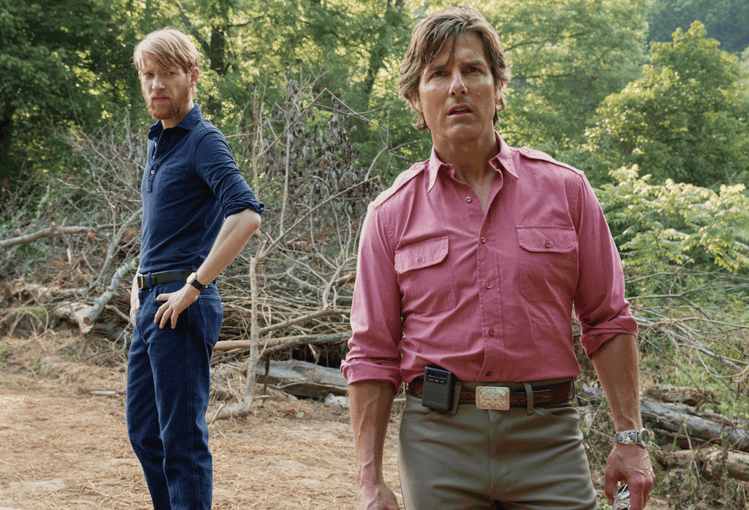 (L–R) Domhnall Gleeson as CIA Agent Schafer and Tom Cruise as blackmailed CIA pilot Barry Seal in Universal Picture’s “American Made.” (David James/Universal Studios)