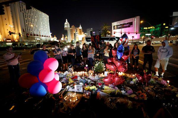 People gather at a makeshift memorial in the middle of Las Vegas Boulevard following the mass shooting in Las Vegas, Nevada on Oct. 4, 2017. (Reuters/Chris Wattie)