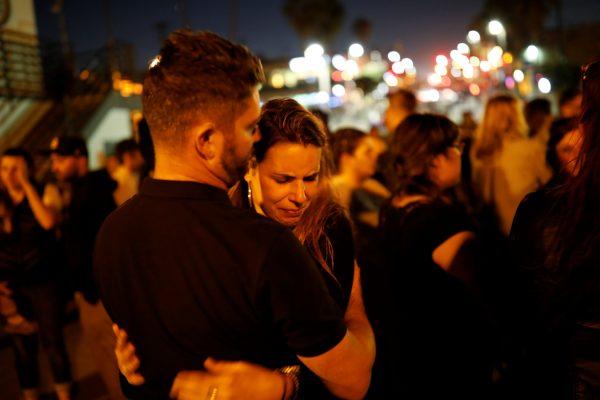 People embrace during a memorial for Rachael Parker and Sandy Casey, victims of the October 1st Las Vegas Route 91 music festival mass shooting, in Manhattan Beach, Calif., on Oct. 4, 2017. (Reuters/Patrick T. Fallon)