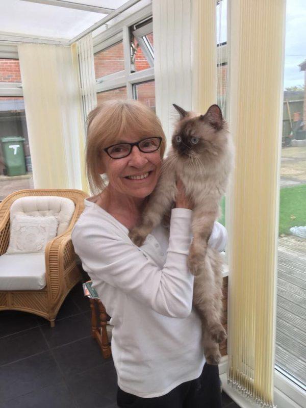 Dinky the cat with his owner, Sue Lees, safely in his new home at last. (Donna Bailey)